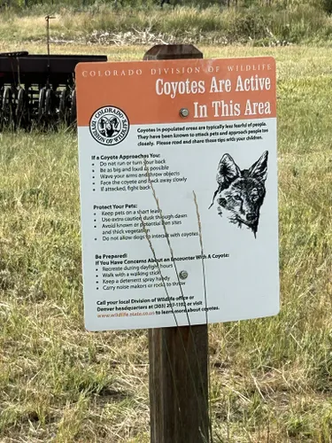 Coyotes in the area warning sign along hiking trail, Colorado US